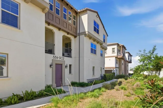 a view of a brick building next to a yard