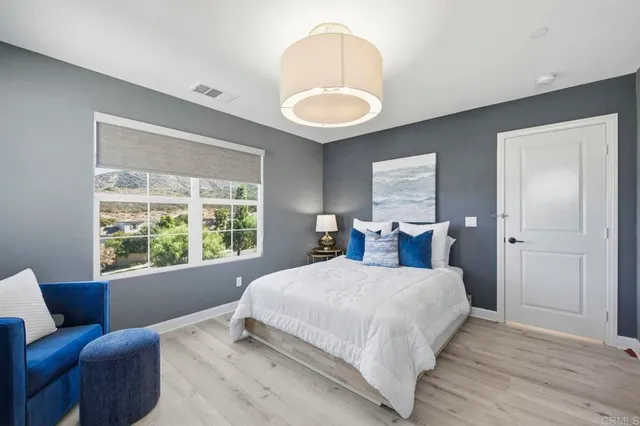 a bedroom with a bed and a large window