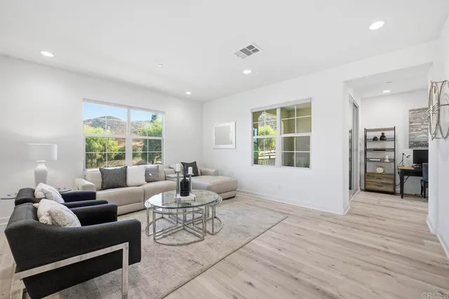 a living room with furniture and large windows