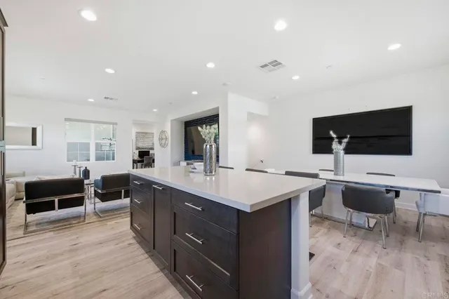 a large kitchen with a table and chairs