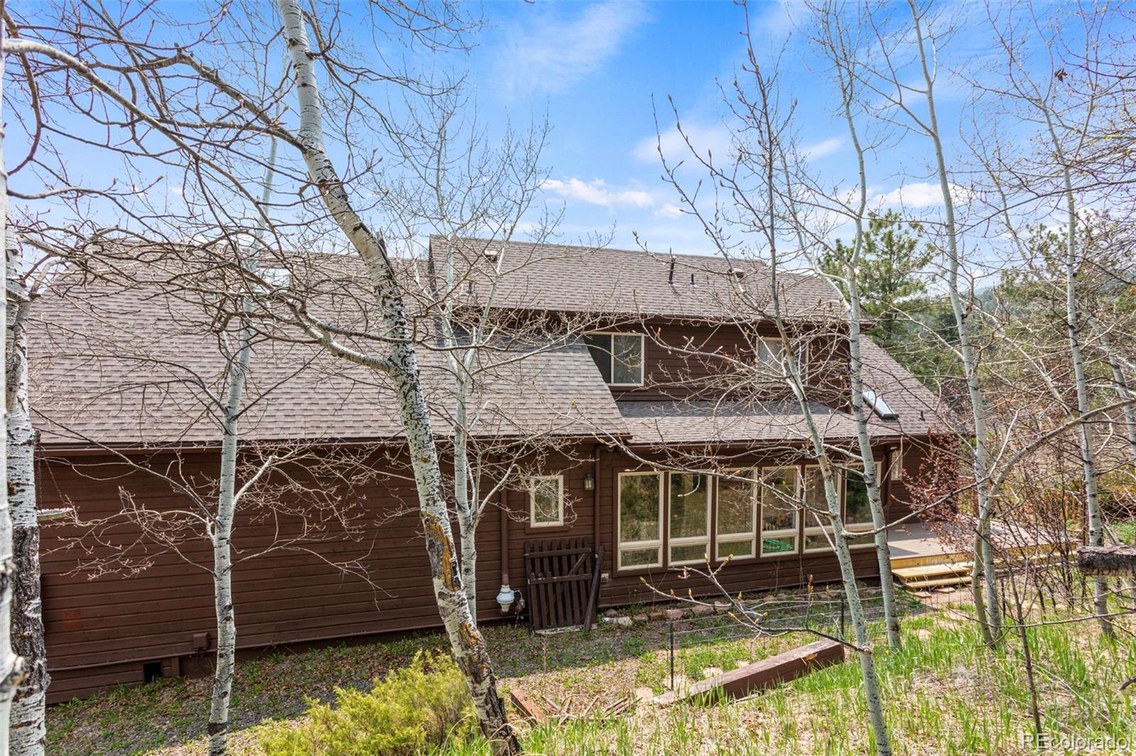12183 Arnett Ranch Road Littleton, CO 80127 - Photo 25 of 28 a view of a house with a yard