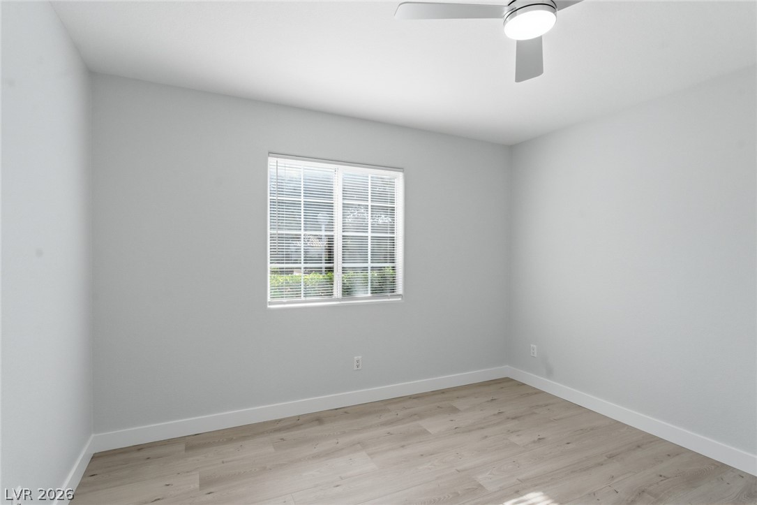 5449 Bugle Way, Unit 104 Las Vegas, NV 89108 - Photo 20 of 33 This spacious room features modern flooring and a large window, creating a bright and airy atmosphere.