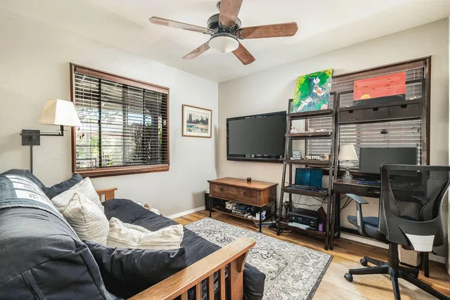 a bedroom with furniture and a flat screen tv