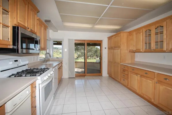a kitchen with stainless steel appliances granite countertop a stove and a sink