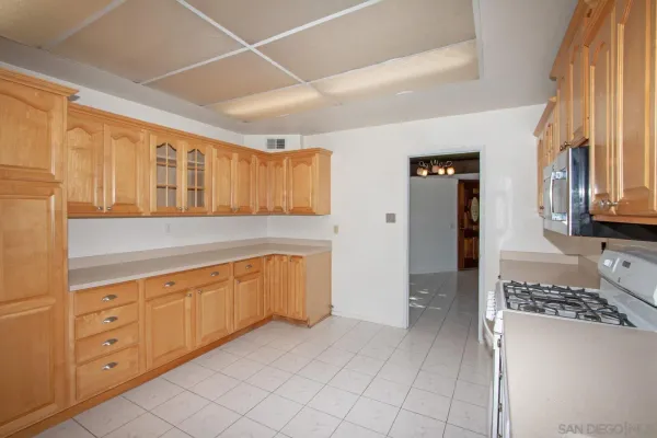 a spacious bathroom with a double vanity sink a mirror and a shower