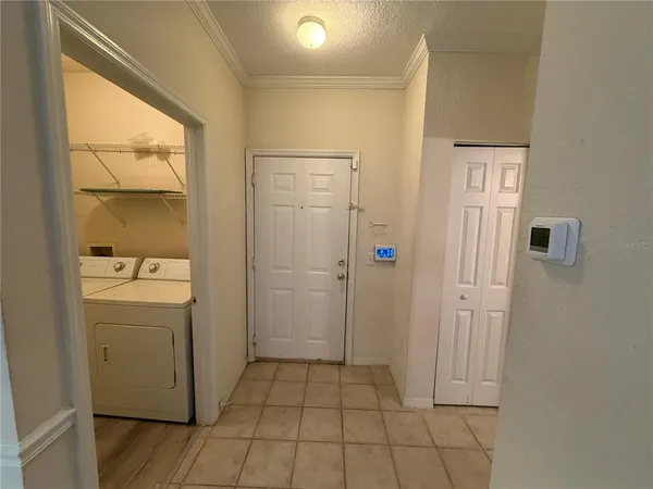 a view of a hallway with washer and dryer