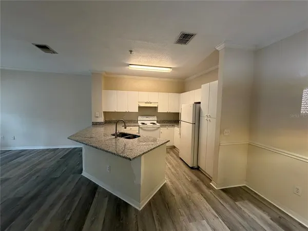 a kitchen with a sink a refrigerator freezer and a stove