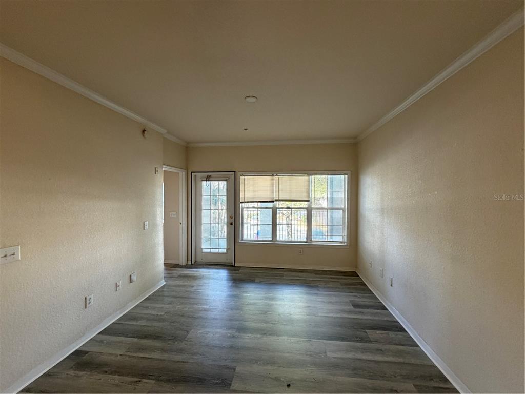 3561 Conroy Road, Unit 225 Orlando, FL 32839 - Photo 6 of 14 wooden floor in an empty room with a window