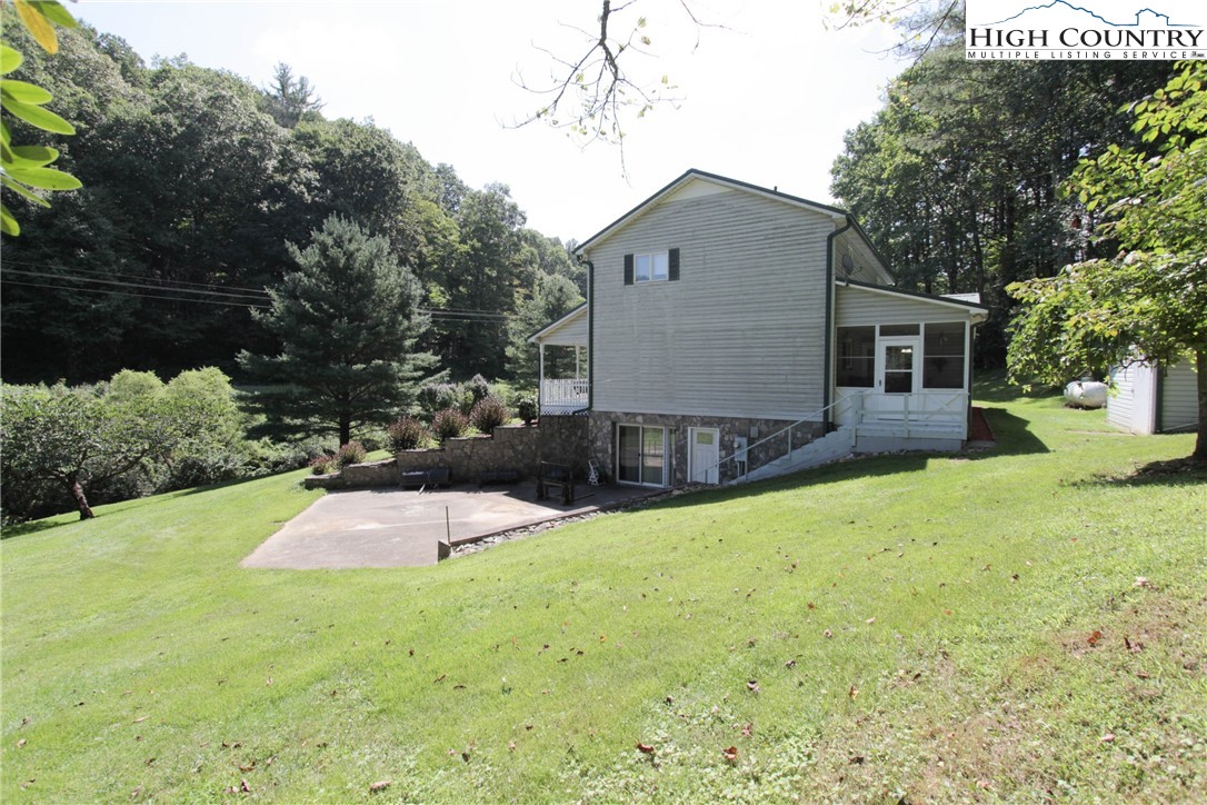 581 North Fork New River Road Lansing, NC 28643 - Photo 5 of 44 a front view of a house with a yard and garage