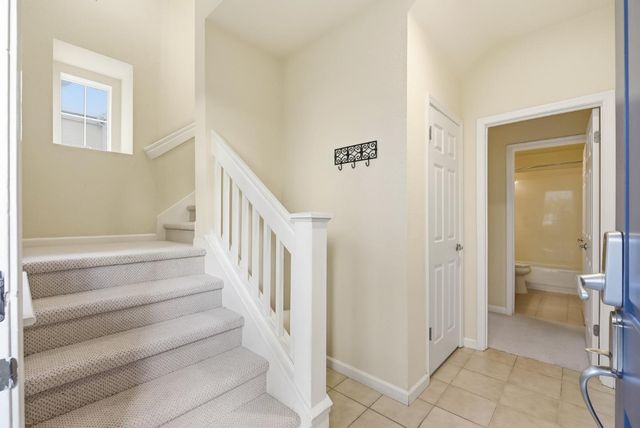 a view of a hallway with a livingroom and a bathroom