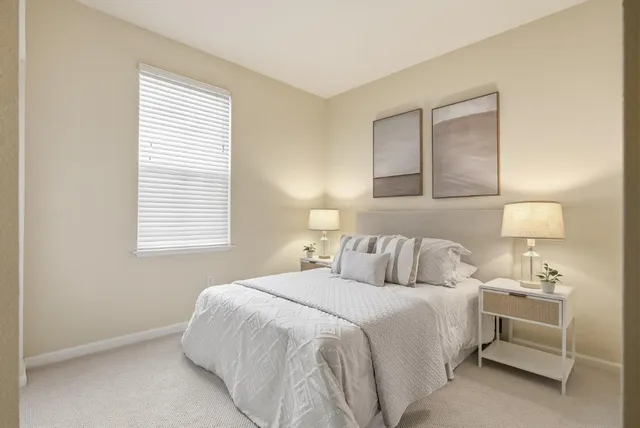 a bedroom with a bed and a night stand