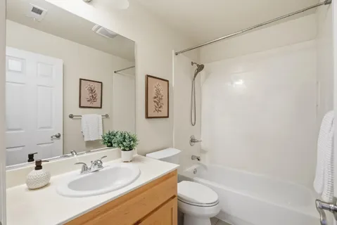 a bathroom with a sink toilet tub and shower