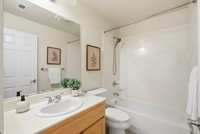 a bathroom with a sink toilet tub and shower