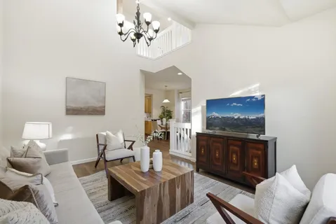 a living room with furniture a dining table and a fireplace