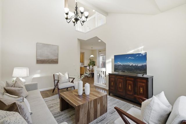 a living room with furniture a dining table and a fireplace