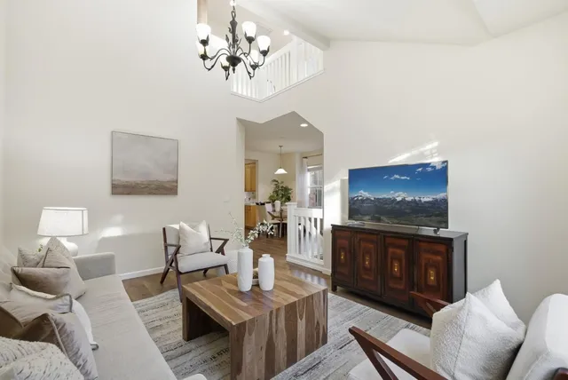 a living room with furniture a dining table and a fireplace