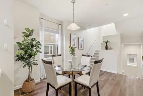 a view of a dining room with furniture window and wooden floor