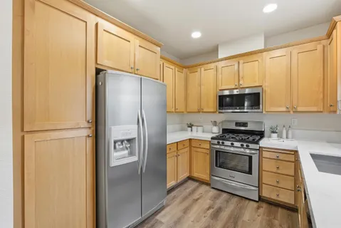 a kitchen with stainless steel appliances a refrigerator stove and sink