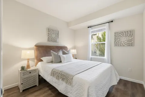 a bedroom with bed and a window