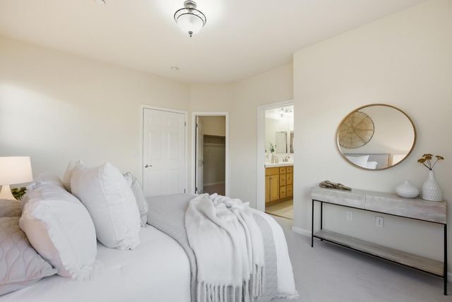 a bedroom with bed and a chandelier