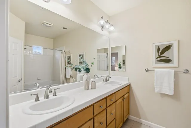 a bathroom with a sink double vanity and a mirror