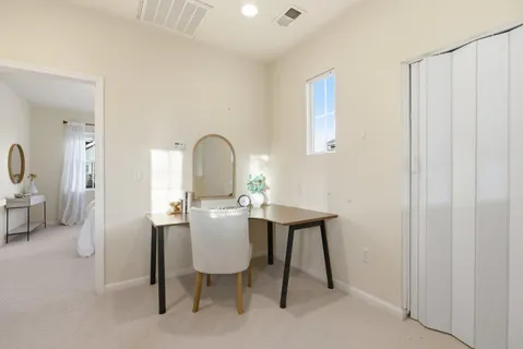 a view of a workspace room with furniture