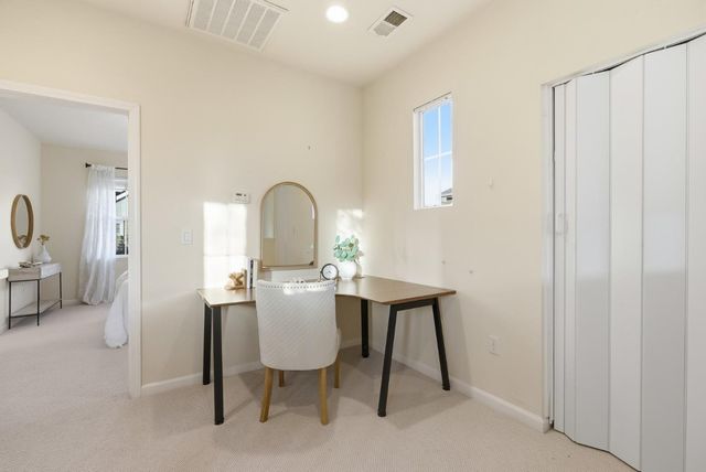a view of a workspace room with furniture