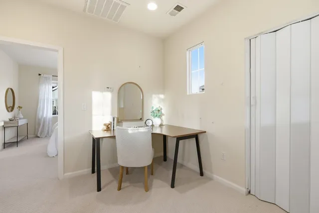 a view of a workspace room with furniture