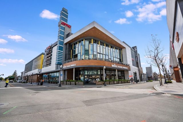 a man walking down a street next to a building