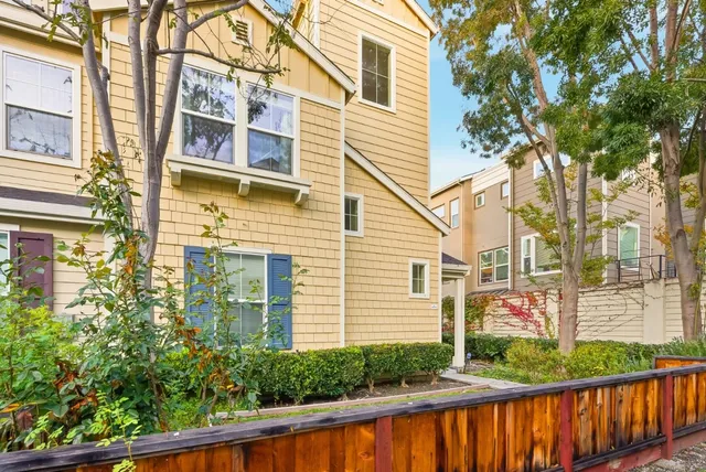 a view of a house with large windows and a small yard