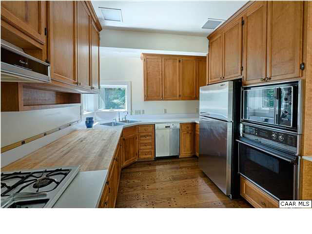1810 Winston Road Charlottesville, VA 22903 - Photo 8 of 22 a kitchen with stainless steel appliances kitchen island granite countertop a refrigerator stove and sink
