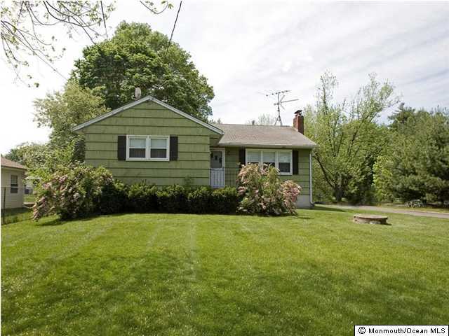 707 Lloyd Road Aberdeen, NJ 07747 - Photo 1 of 3 a front view of a house with a yard and trees