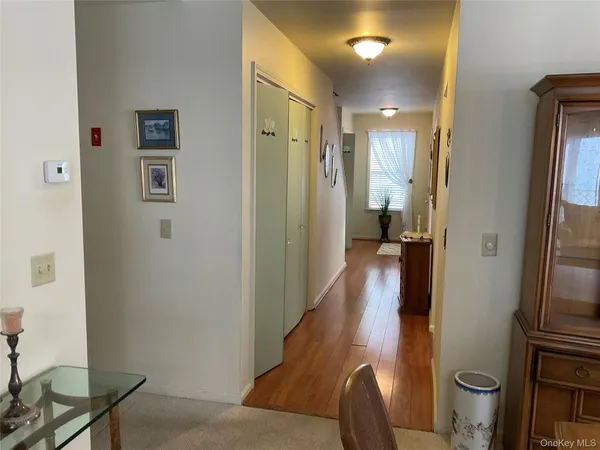 a view of a hallway with a livingroom and furniture