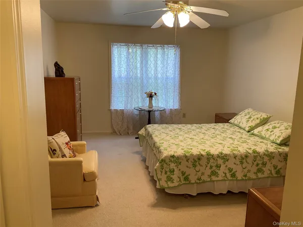 a bedroom with bed and window