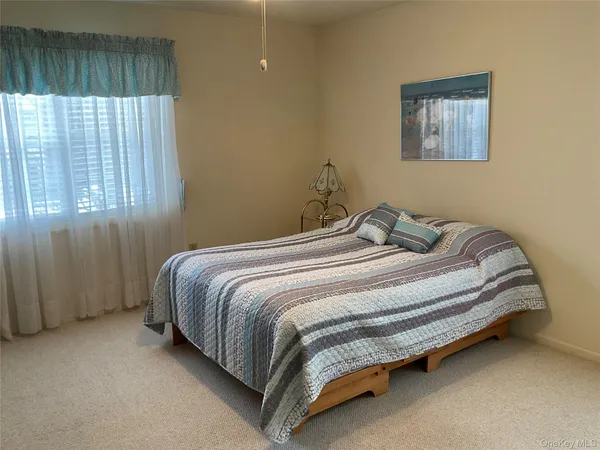 a bedroom with a bed and window