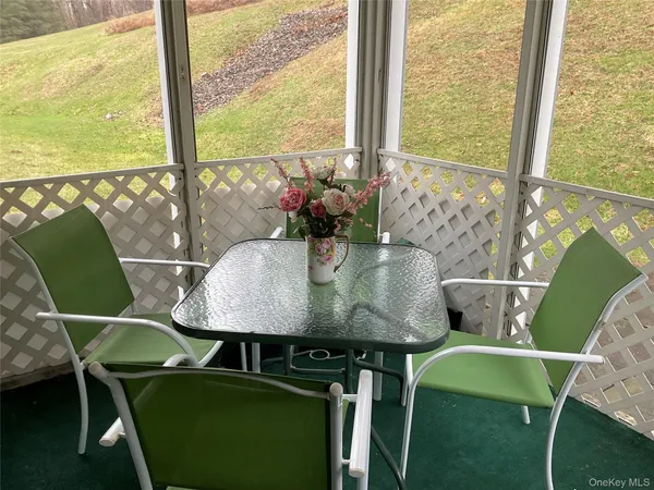 a view of a dining room with furniture and window
