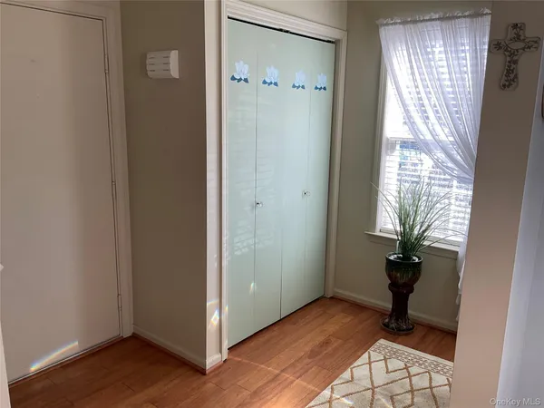 a view of a livingroom with wooden floor and a window