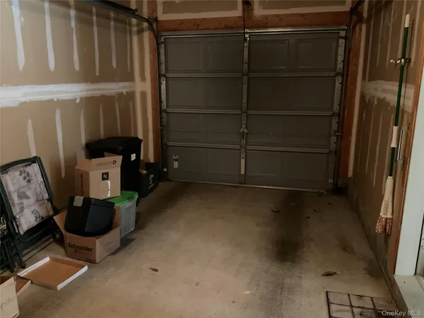 a view of an empty room with wooden floor and a cabinet