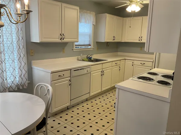 a kitchen with cabinets a stove and a refrigerator
