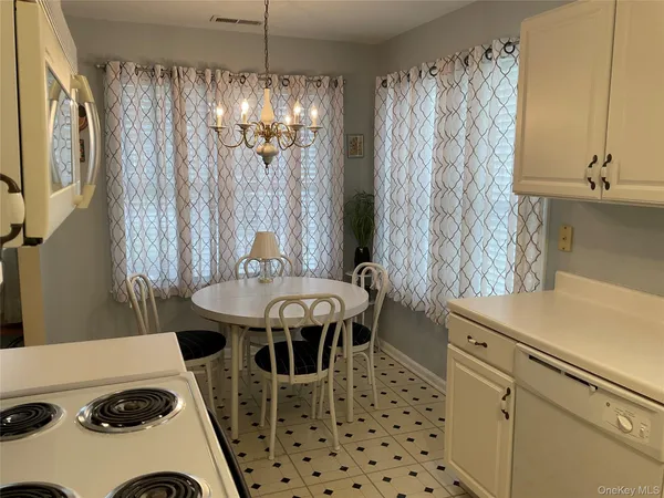 a dining room with a table and chairs