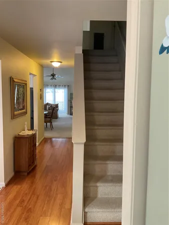 a view of living room filled with furniture and wooden floor