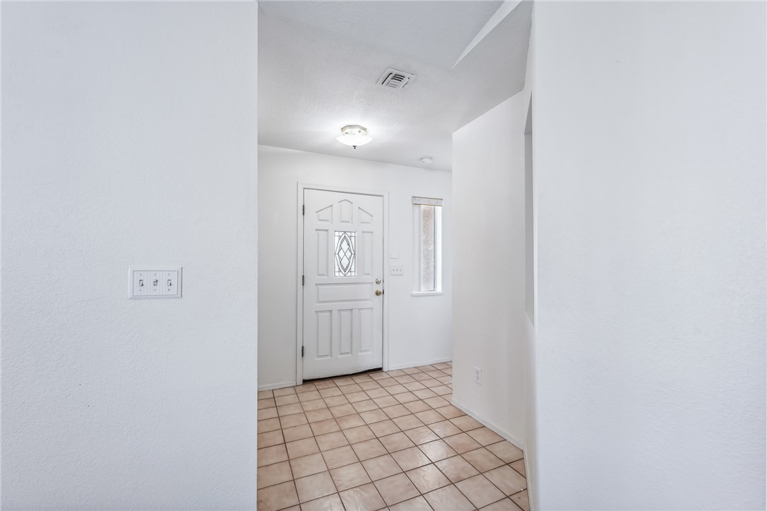 2524 South Ridge Avenue Bullhead City, AZ 86429 - Photo 10 of 64 Corridor with light tile patterned flooring and baseboards
