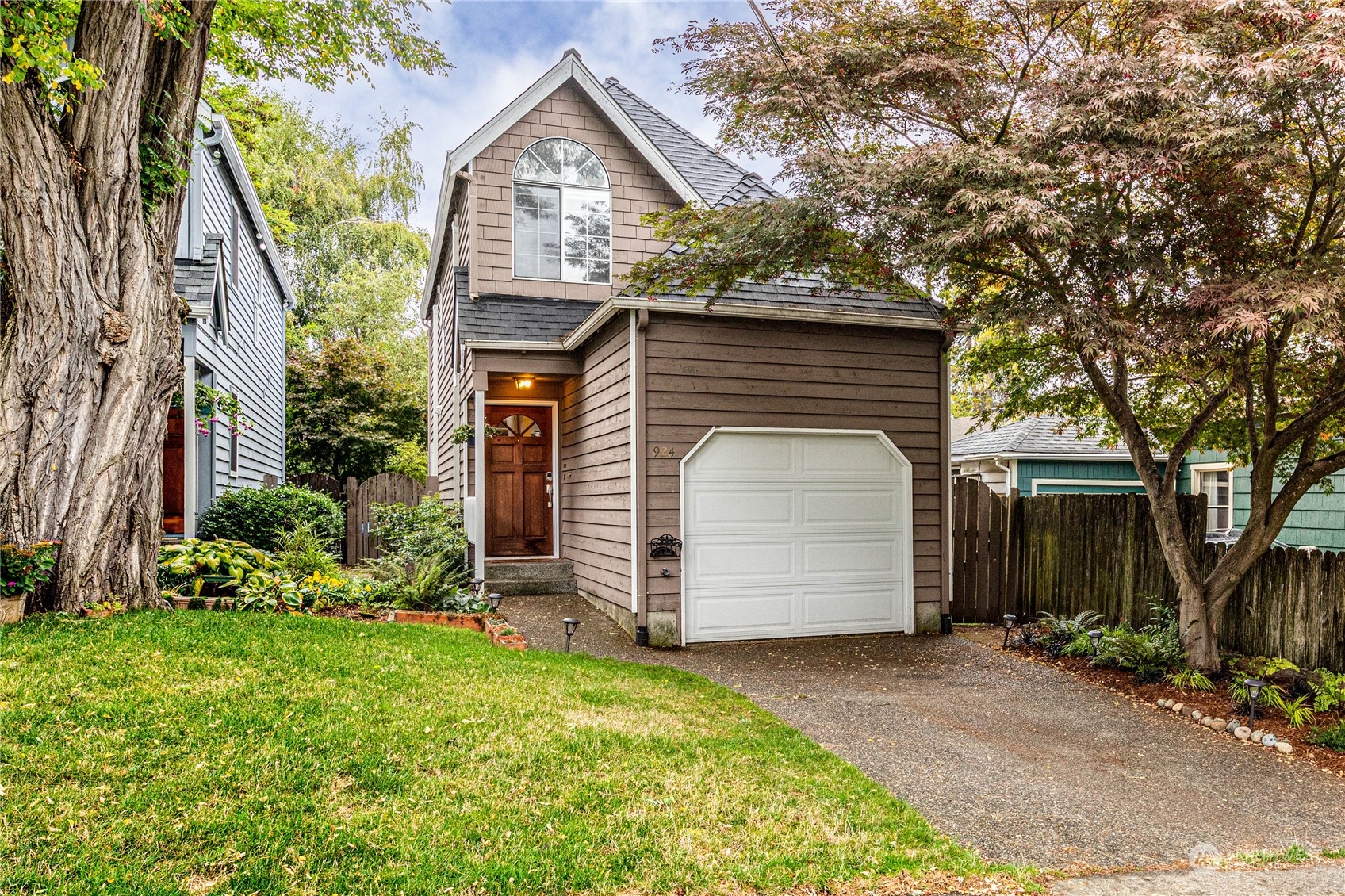 924 North 86th Street Seattle, WA 98103 - Photo 1 of 27 a front view of a house with a garden