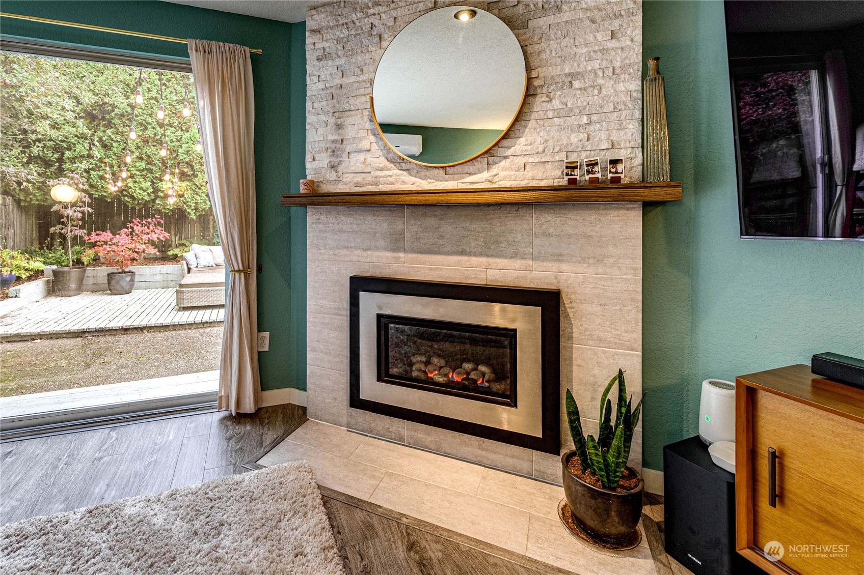 924 North 86th Street Seattle, WA 98103 - Photo 14 of 27 a living room with a fireplace and a floor to ceiling window