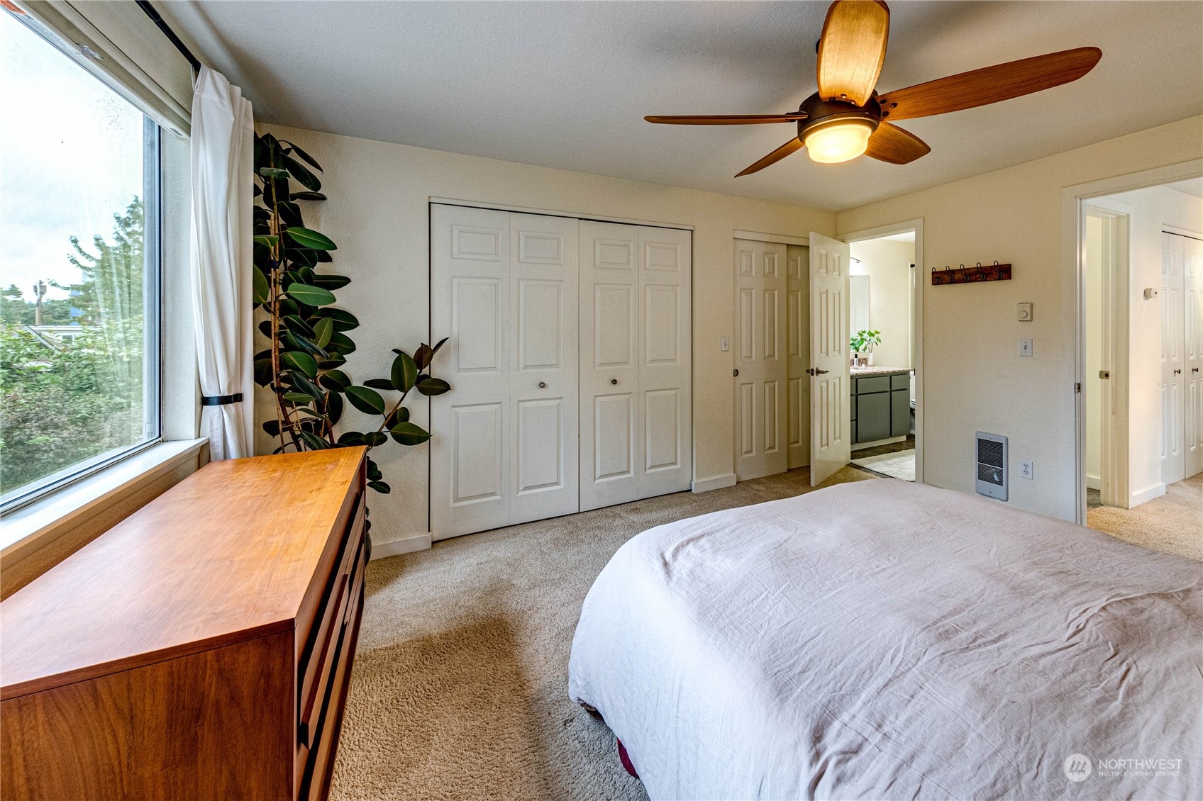 924 North 86th Street Seattle, WA 98103 - Photo 17 of 27 a bedroom with a bed and a chandelier