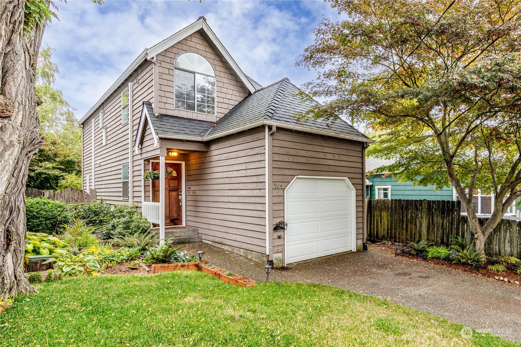 924 North 86th Street Seattle, WA 98103 - Photo 2 of 27 a front view of a house with a yard and garage