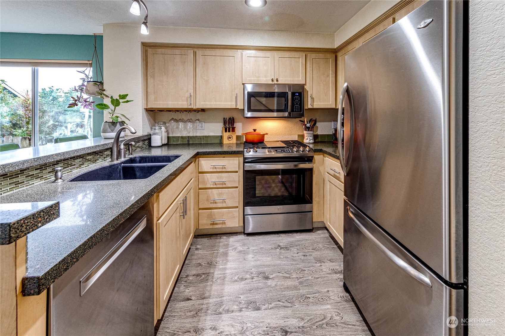 924 North 86th Street Seattle, WA 98103 - Photo 8 of 27 a kitchen with granite countertop a refrigerator sink and stove