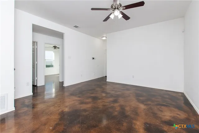 a view of an empty room and wooden floor