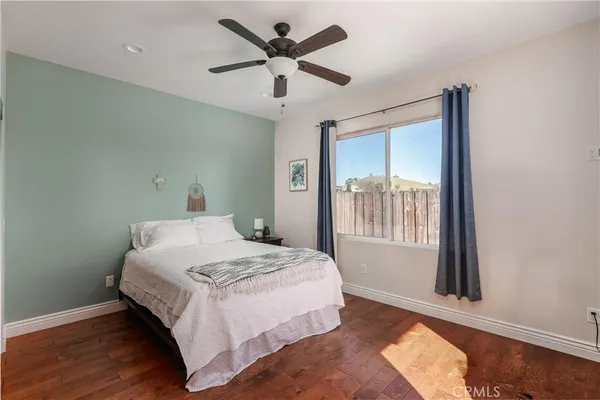 a bedroom with a large bed and a window