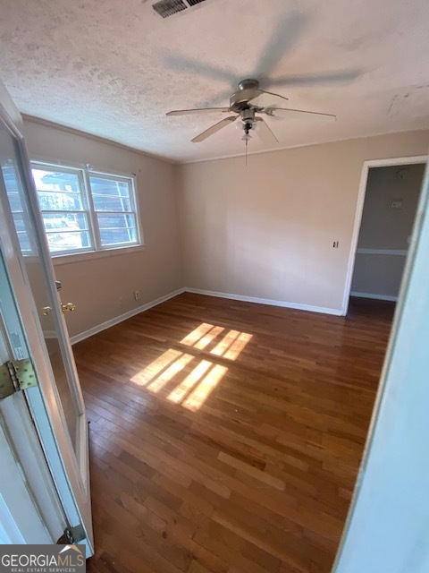 121 Sunset Drive Northeast Calhoun, GA 30701 - Photo 19 of 33 an empty room with wooden floor fan and windows